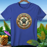 Blue t-shirt with a circular crest featuring a turtle, palm trees, hibiscus flowers, and waves.