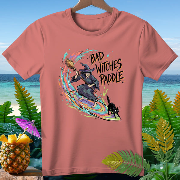 T-shirt with a witch and cat surfing, text reads "Bad Witches Paddle".