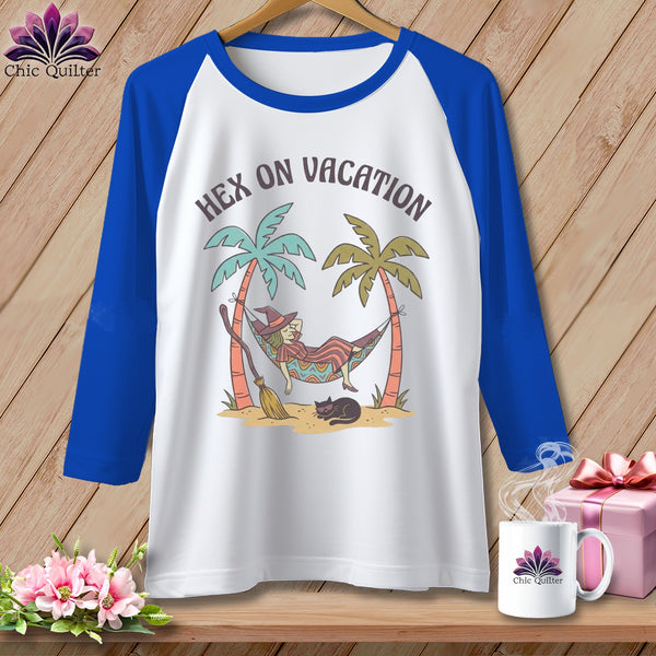T-shirt graphic of a witch relaxing in a hammock between palm trees with text "Hex on Vacation".