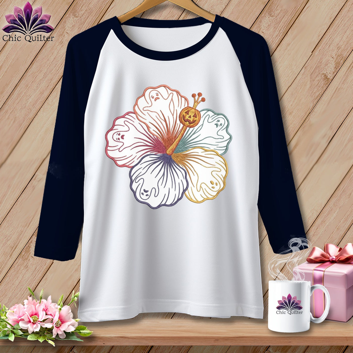Raglan sleeve shirt with white body and navy sleeves, featuring a colorful hibiscus with ghost and jack-o'-lantern accents.