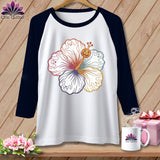 Raglan sleeve shirt with white body and navy sleeves, featuring a colorful hibiscus with ghost and jack-o'-lantern accents.