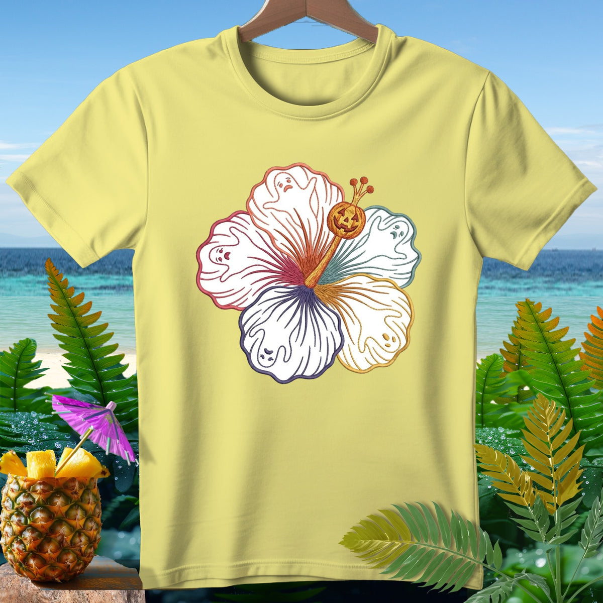 Yellow t-shirt with a hibiscus flower graphic featuring ghosts and a jack-o'-lantern.