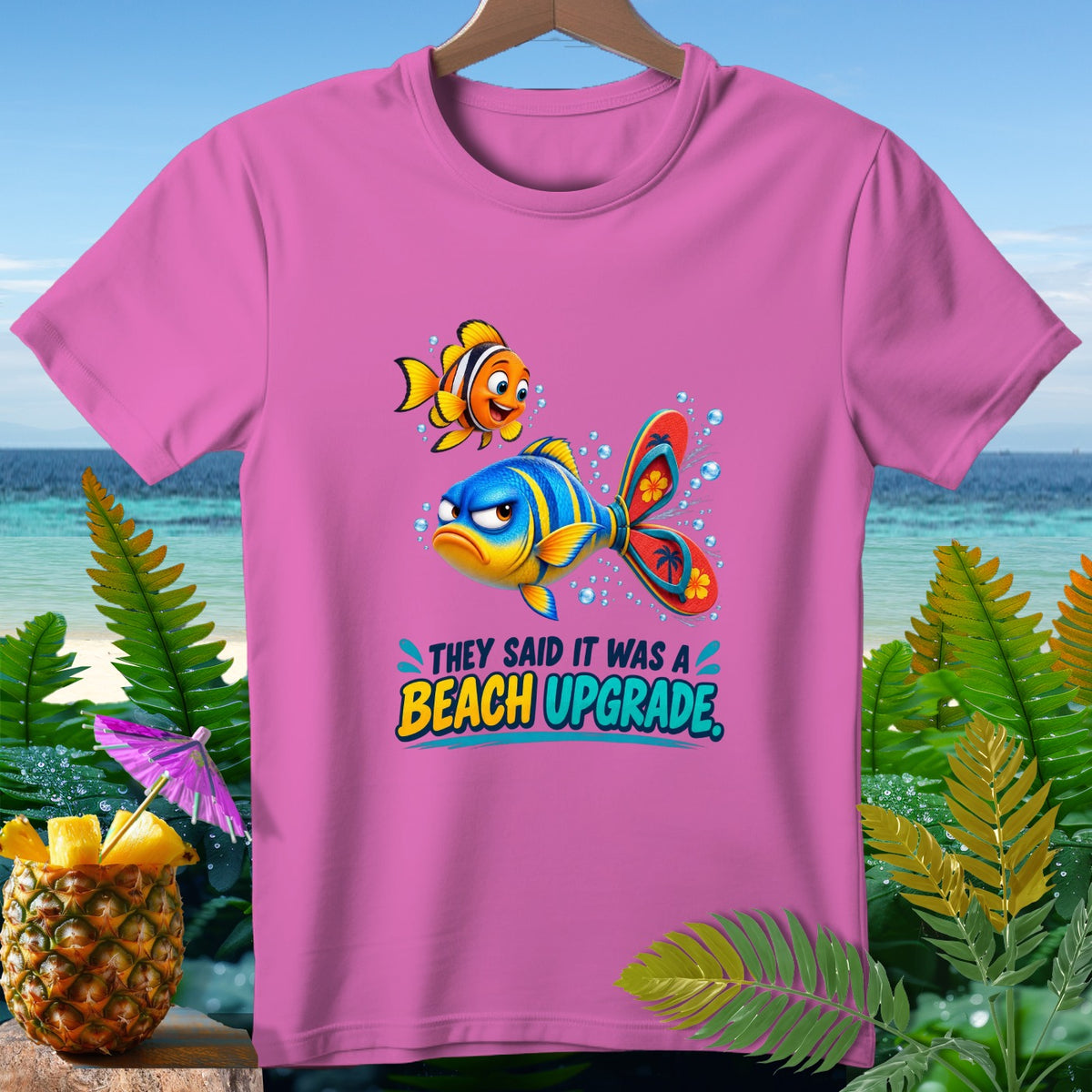 Pink t-shirt with cartoon fish and text "They Said It Was a Beach Upgrade."