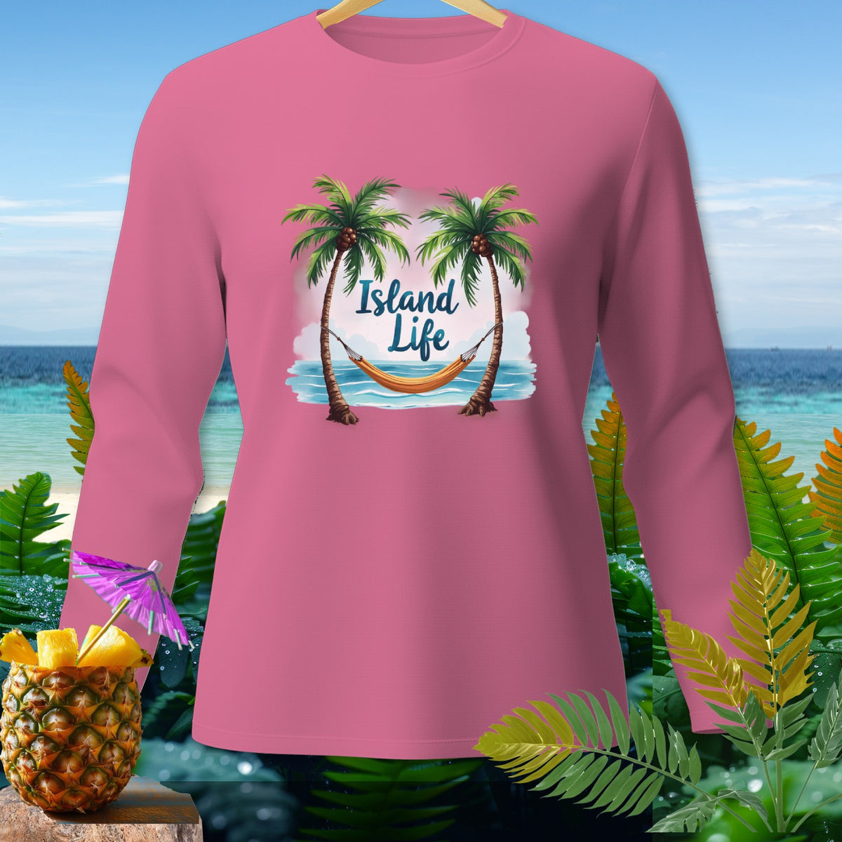 Pink long sleeve shirt with "Island Life" graphic of palm trees and hammock.