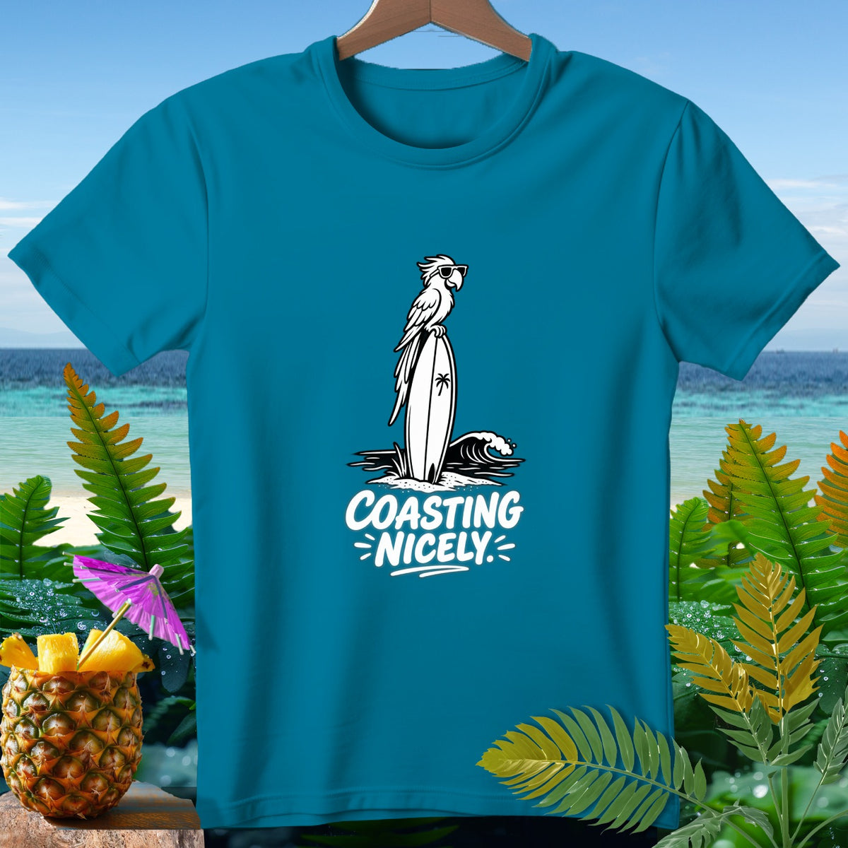Teal t-shirt with white graphic of parrot on surfboard, "COASTING NICELY" text.