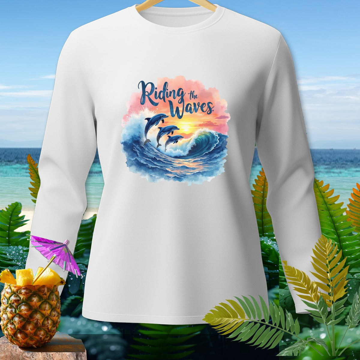 White long-sleeved shirt with dolphins riding a wave and the text "Riding the Waves".