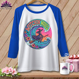 White baseball tee with a witch riding a broomstick through a wave.