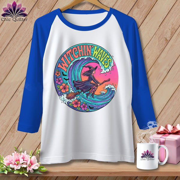 White baseball tee with a witch riding a broomstick through a wave.