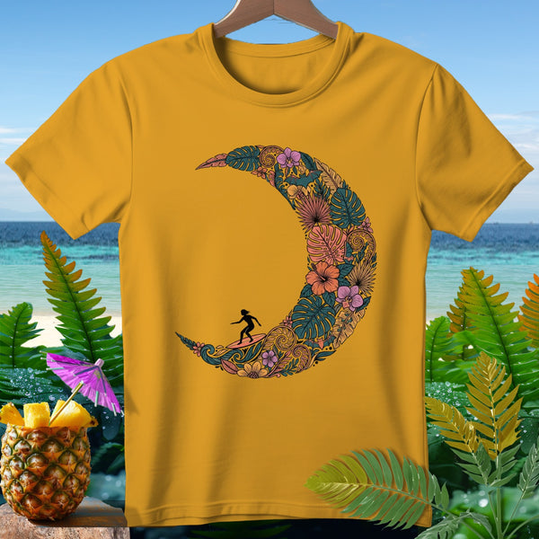 Yellow t-shirt with a crescent moon design filled with tropical leaves and flowers, featuring a surfer silhouette.