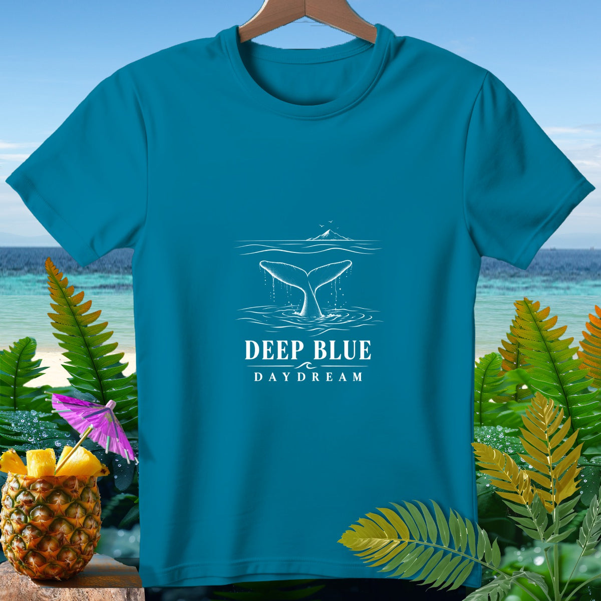 Teal t-shirt with white whale tail and text "DEEP BLUE DAYDREAM".