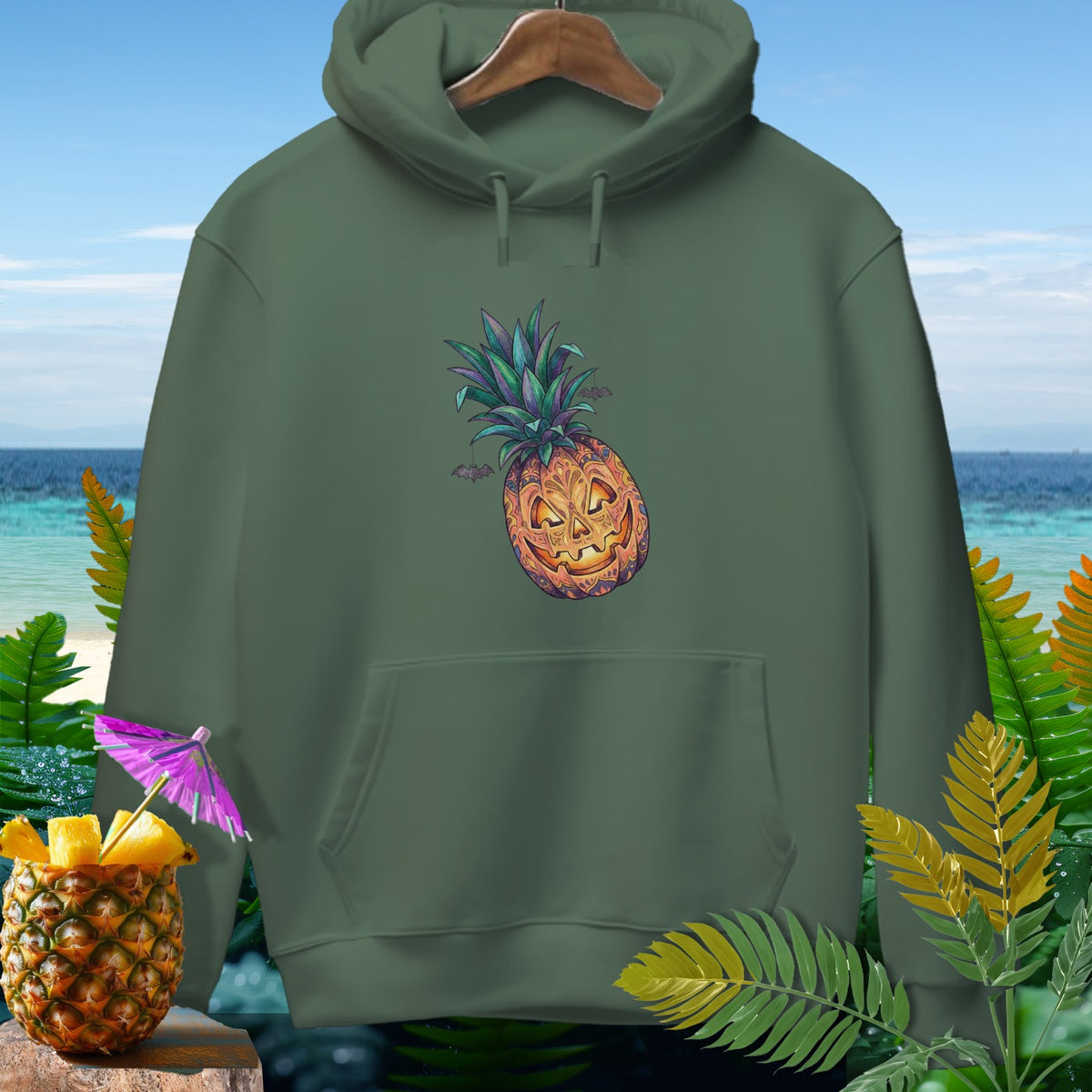 Green hoodie with a jack-o'-lantern pineapple and bats graphic.