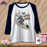 White raglan t-shirt with a witch, black cat, and 