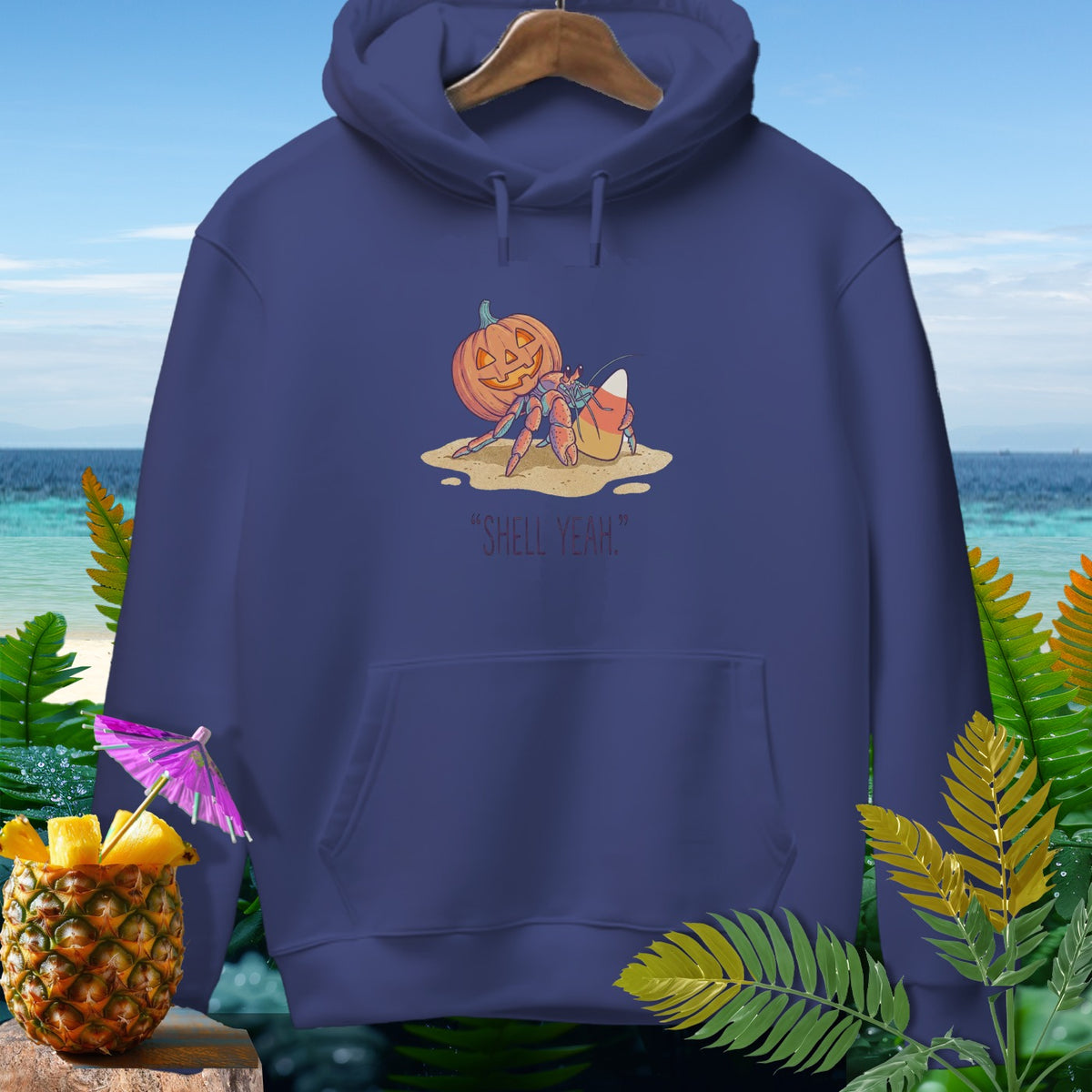 Hermit crab with pumpkin and candy corn, "SHELL YEAH" text on hoodie.