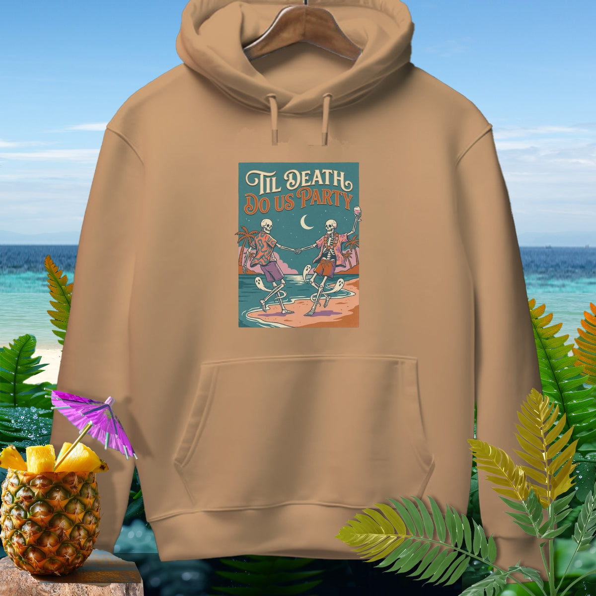 Tan hoodie with "Til Death Do Us Party" graphic of skeletons dancing on a beach.