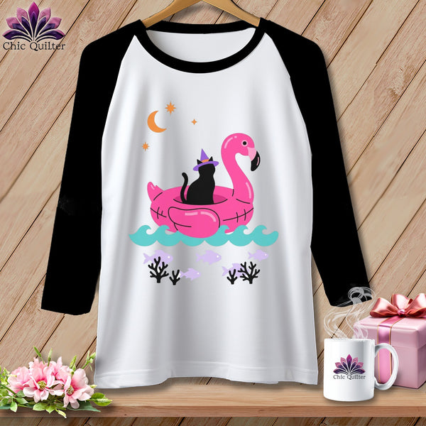 Raglan sleeve shirt with graphic of black cat on pink flamingo float.