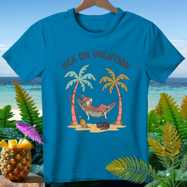 Blue t-shirt with "Hex on Vacation" text, a witch in a hammock, palm trees, and a cat.