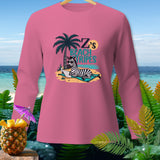 Pink long sleeve shirt with a zebra reading on the beach graphic.