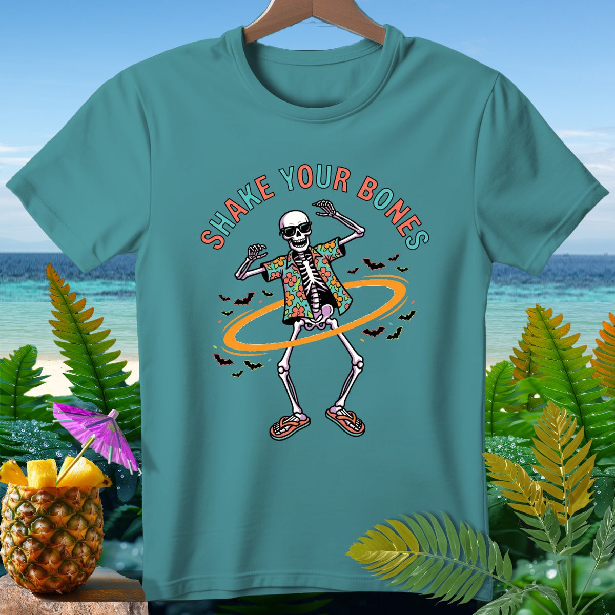 Teal t-shirt with skeleton dancing, Hawaiian shirt, sunglasses, and text "Shake Your Bones."