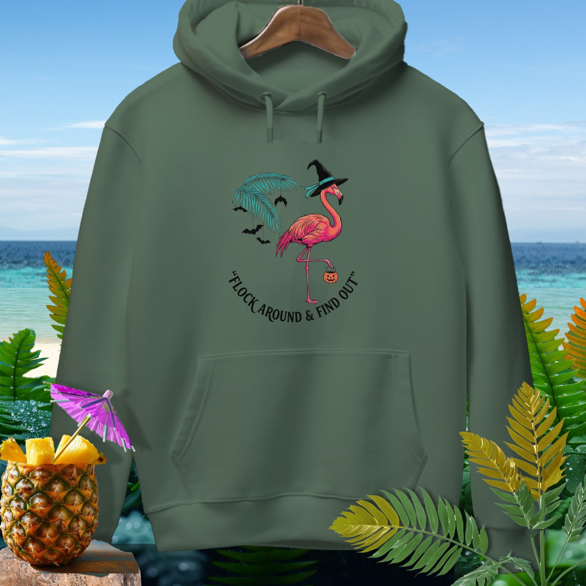 Green hoodie with Halloween flamingo graphic and text "Flock Around & Find Out".
