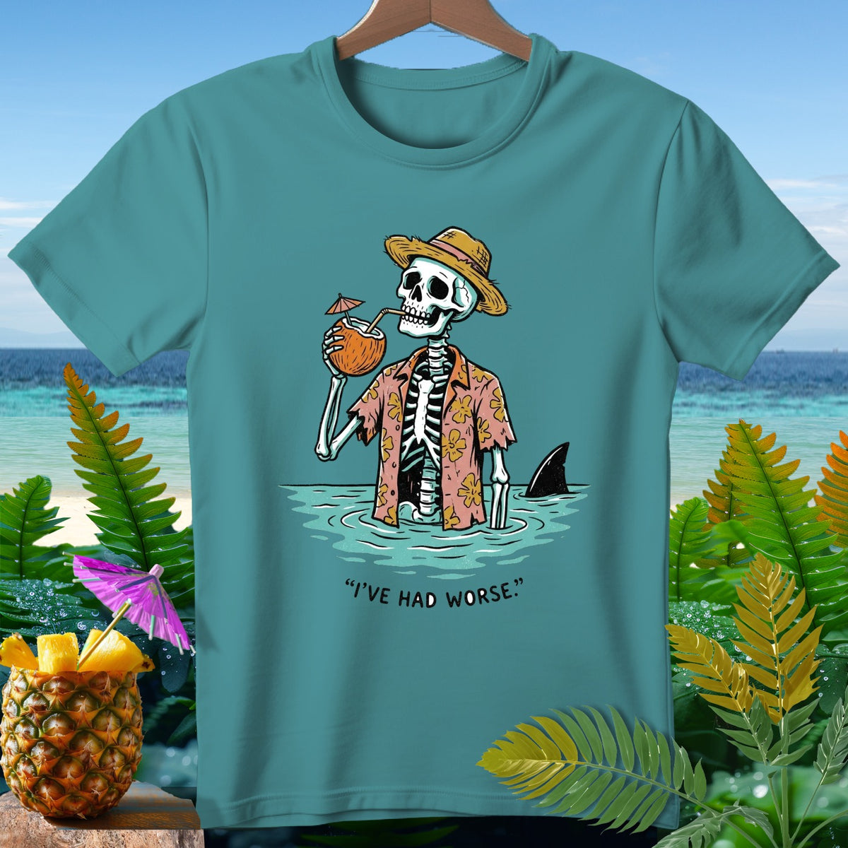 Skeleton in Hawaiian shirt drinking coconut, shark fin visible, text "I'VE HAD WORSE."