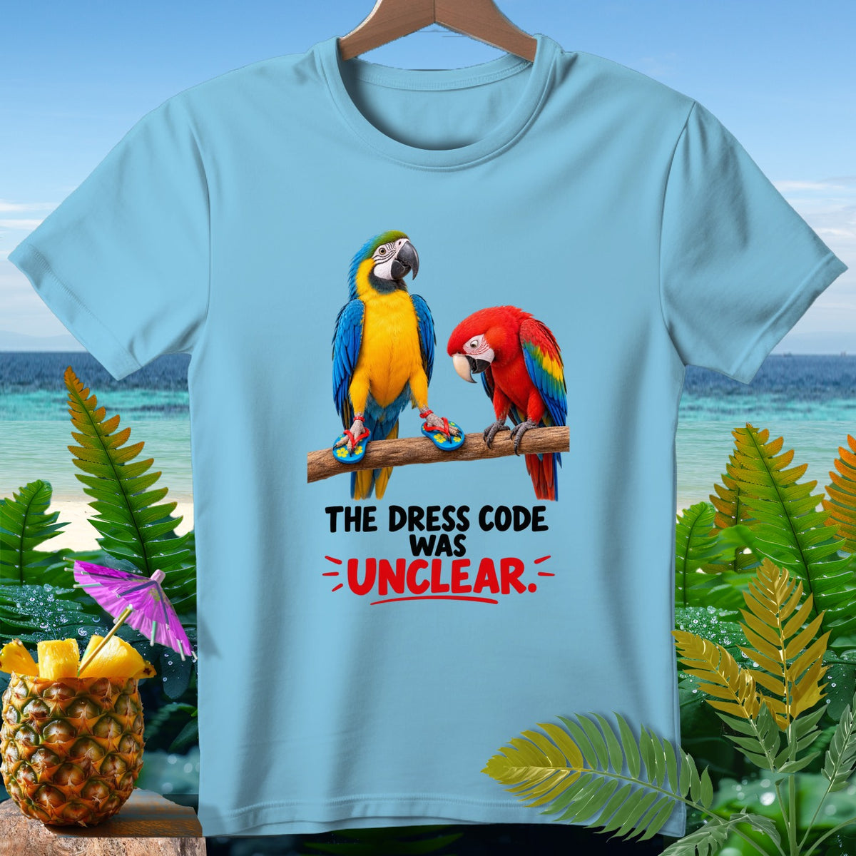 Light blue t-shirt with two parrots wearing flip-flops and text "THE DRESS CODE WAS UNCLEAR."