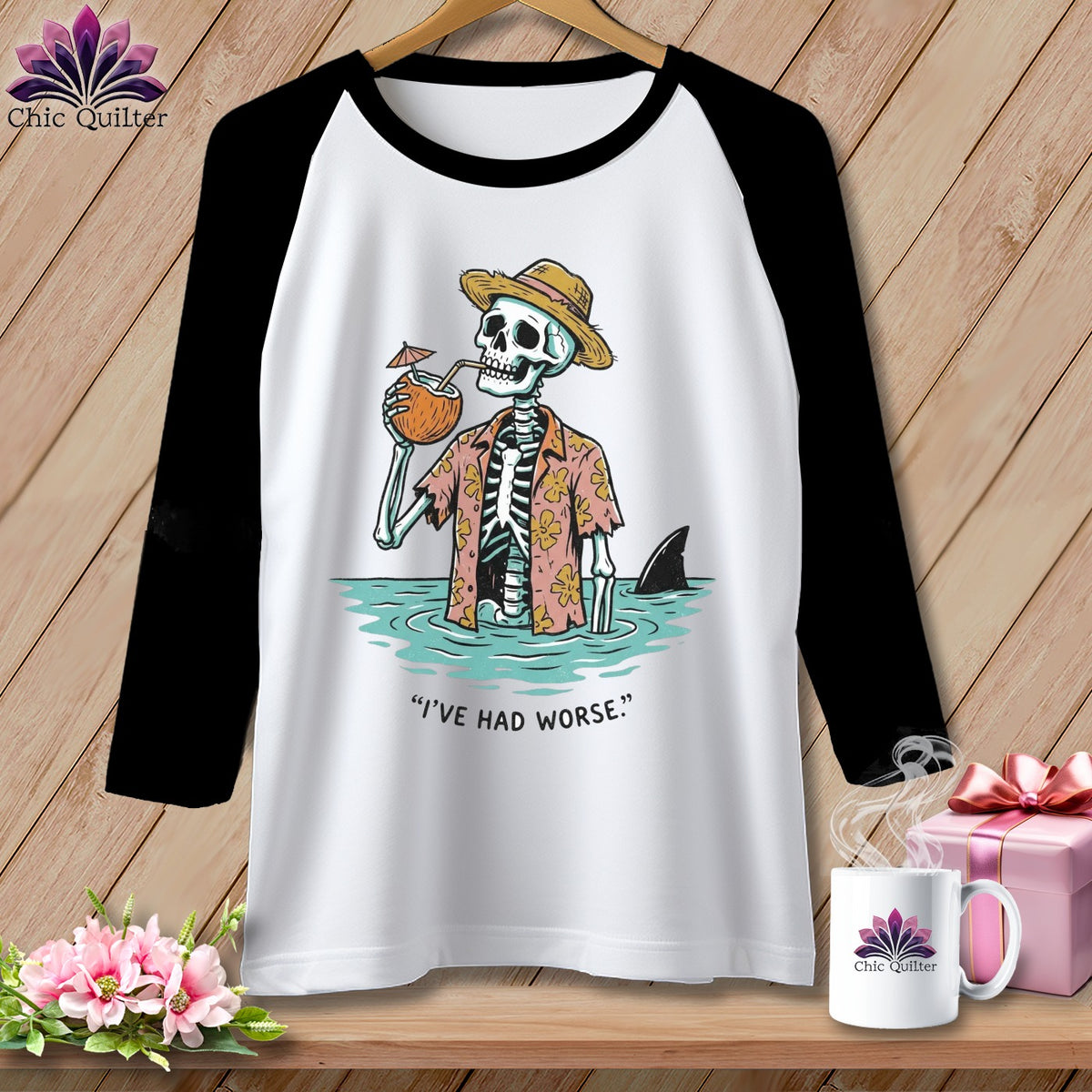 Black and white raglan t-shirt with skeleton in Hawaiian shirt, drinking coconut, in water with shark.