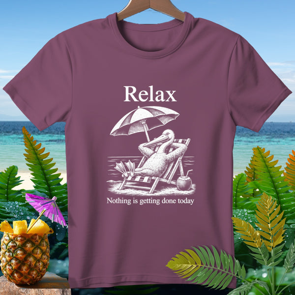 T-shirt with a pelican relaxing under an umbrella on a beach, text "Relax Nothing is getting done today".