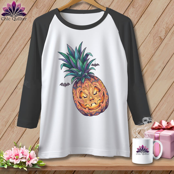 White baseball tee with jack-o'-lantern pineapple graphic and bats.