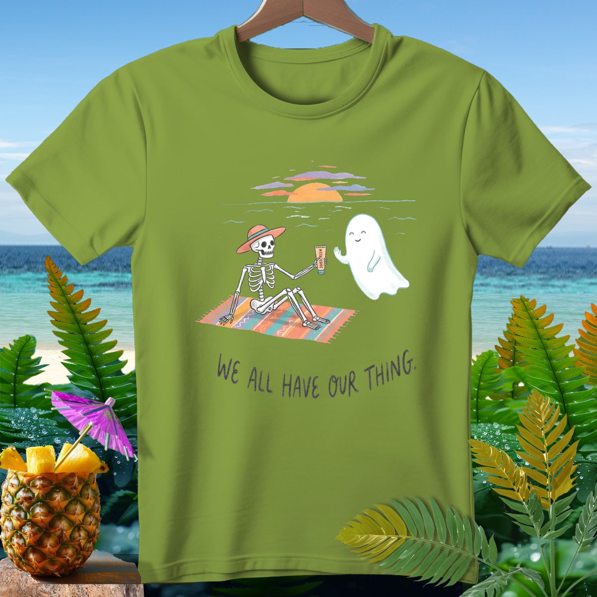 Skeleton and ghost on beach with text "WE ALL HAVE OUR THING."