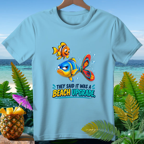 Light blue t-shirt with cartoon fish and text "They said it was a Beach Upgrade".