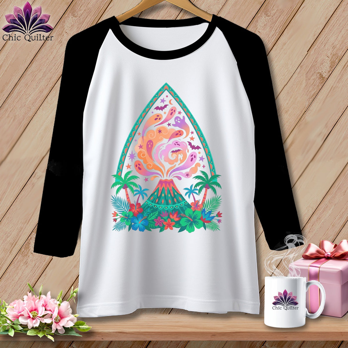 White raglan shirt with colorful volcano, ghosts, bats, and tropical foliage design.