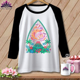 White raglan shirt with colorful volcano, ghosts, bats, and tropical foliage design.