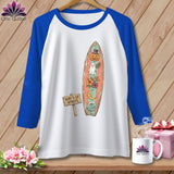 White t-shirt with blue sleeves, featuring a surfboard graphic with pumpkin, ghost, and moon.