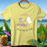 Yellow t-shirt with skeleton and ghost on a beach blanket, text reads 