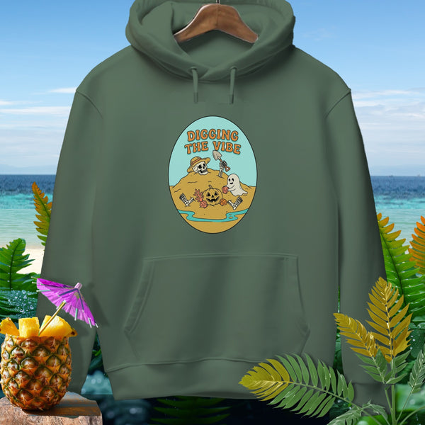 Green hoodie with oval graphic of skeleton and ghost digging on beach, reading "DIGGING THE VIBE".
