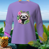 Purple long-sleeved shirt with a sloth face surrounded by tropical flowers and leaves.