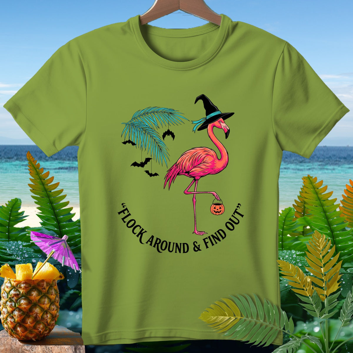 Pink flamingo in witch hat holds pumpkin bucket, text reads "Flock Around & Find Out".