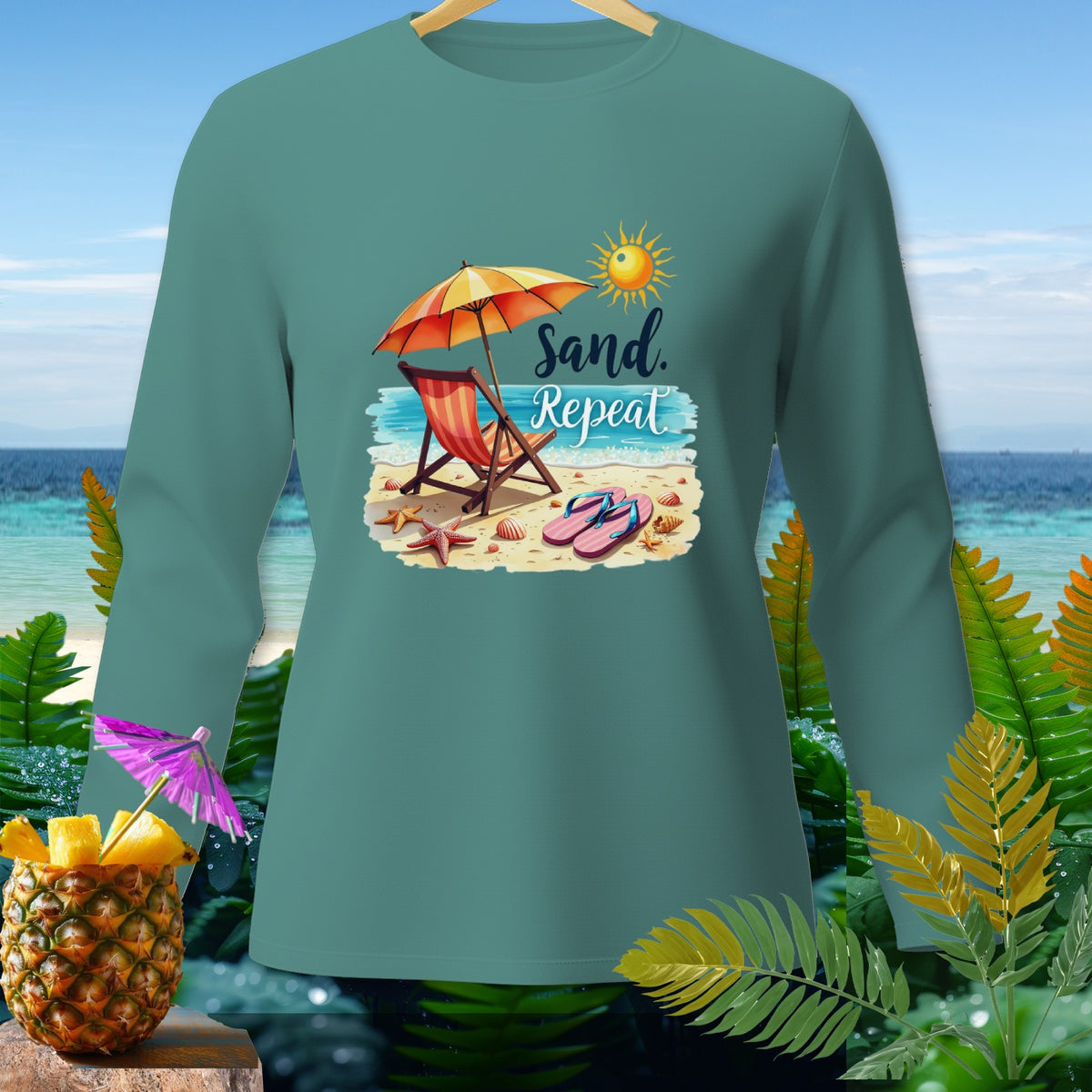 Teal long-sleeve shirt with "Sand. Repeat" beach graphic.