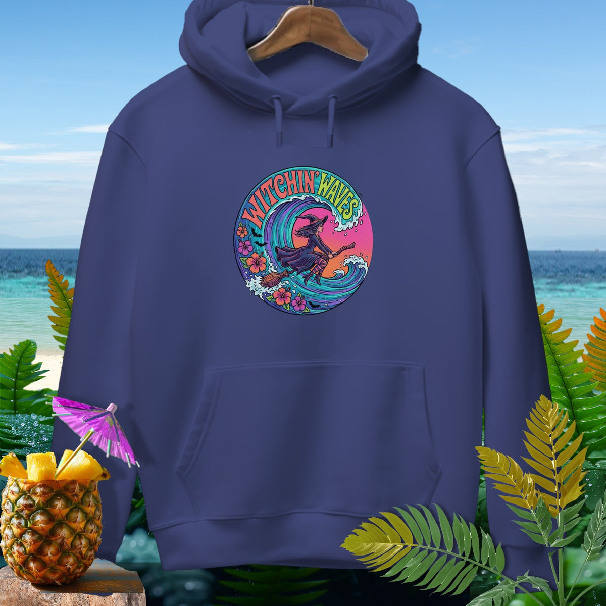 Navy hoodie with a circular graphic of a witch surfing a wave, text reads "Witchin Waves".