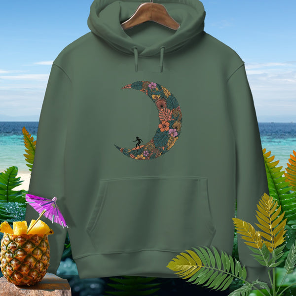 Green hoodie with floral crescent moon and surfer graphic, on beach background.