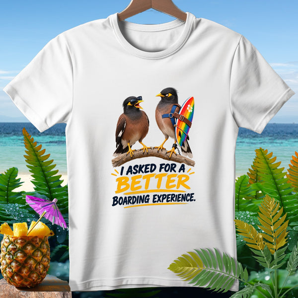 White t-shirt with two birds on a branch, one wearing sunglasses and holding a surfboard with rainbow colors. Text reads "I ASKED FOR A BETTER BOARDING EXPERIENCE."