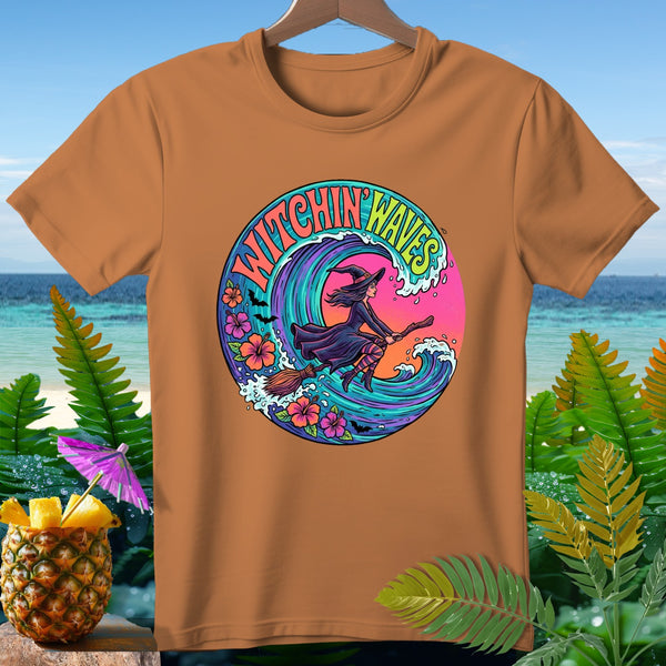 Orange t-shirt with a circular graphic featuring a witch on a broomstick and the text "Witchin' Waves."