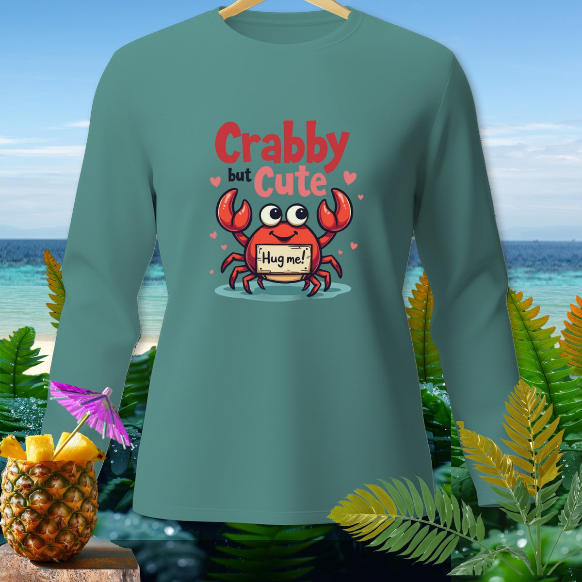 Teal long-sleeve shirt with cartoon crab that says "Crabby but Cute."