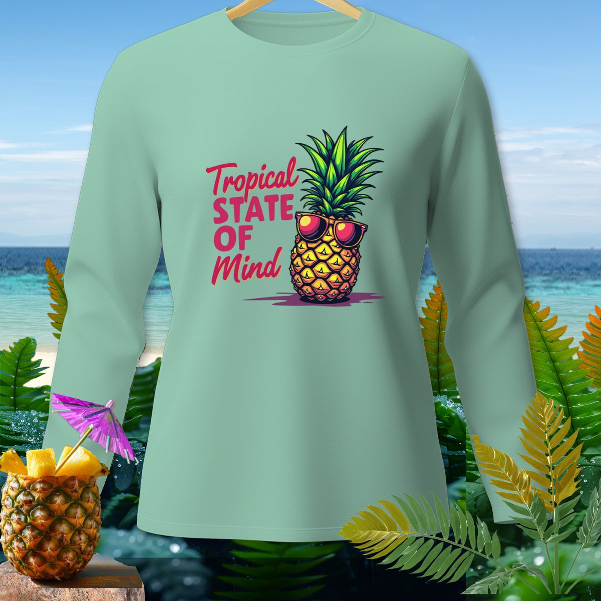 Mint long-sleeve shirt with pineapple wearing sunglasses and "Tropical State of Mind" text.