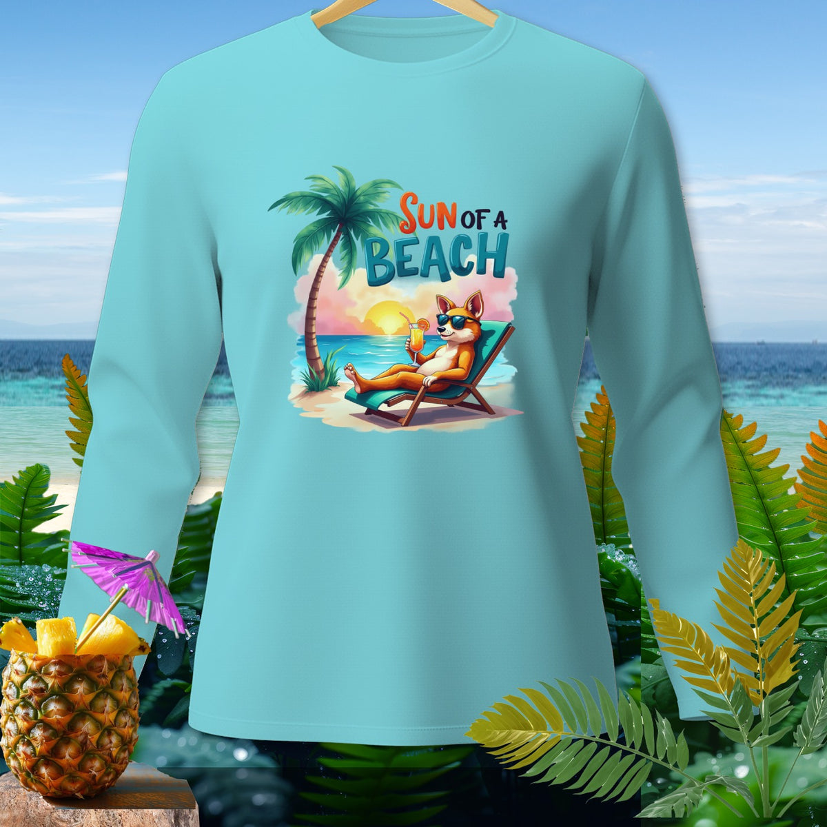 Light blue long-sleeve shirt with a cartoon dog relaxing on a beach with text "SUN OF A BEACH".