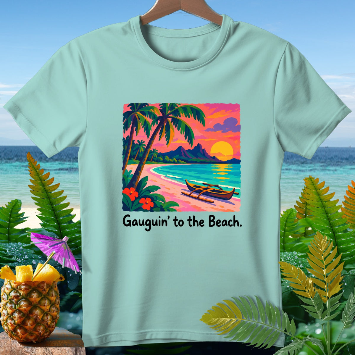 Light blue t-shirt with tropical beach sunset graphic and text "Gauguin' to the Beach."