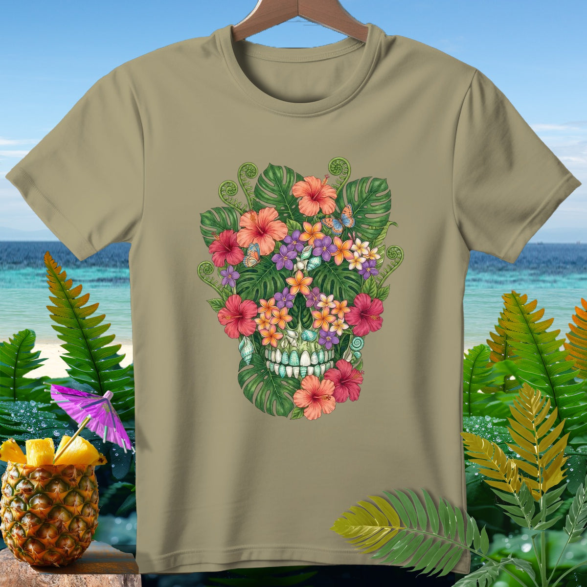 Tan t-shirt with a tropical floral skull design, featuring butterflies and seashells.