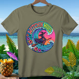 Olive green t-shirt with circular graphic of witch flying on broom over colorful wave and flowers.
