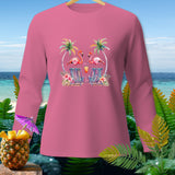 Pink long-sleeve shirt with flamingos, palm trees, and beach chairs graphic.