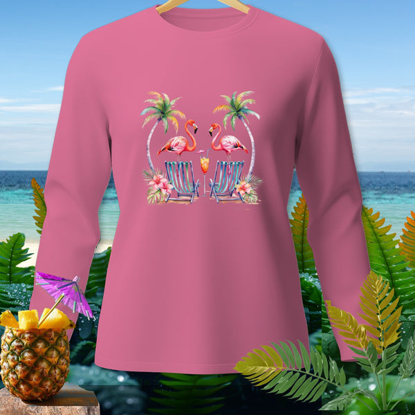 Pink long-sleeve shirt with flamingos, palm trees, and beach chairs graphic.